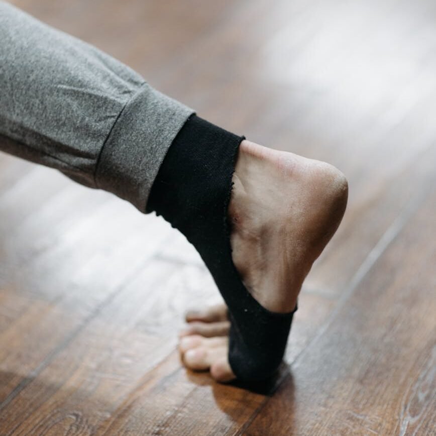 person stretching ankle
